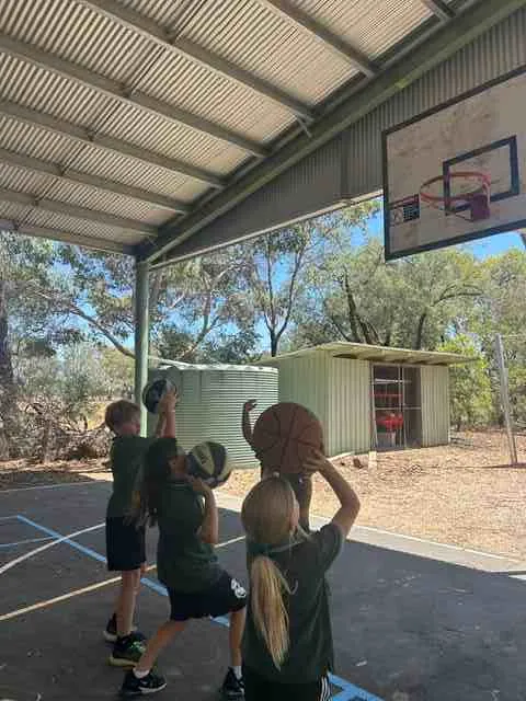 Carra students shooting hoops on the covered basketball court